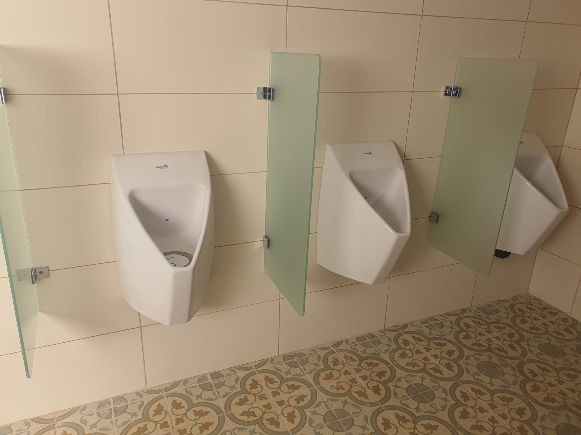 משתנות ללא מים עם מחיצות זכוכית במסעדה